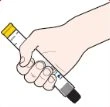A hand firmly holding a white injection pen with a yellow cap and black base angled downward