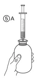 A hand holds a vial with a syringe inserted into the stopper to aspirate liquid, with the label 5A next to the syringe