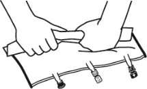 Two hands holding and pulling strongly on the ends of a white fabric strip secured with small metal hooks