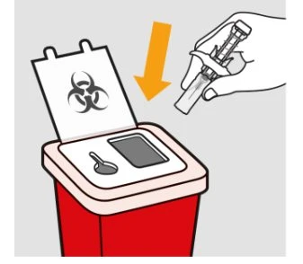 A hand disposing of an empty syringe into a red biohazard waste container with biohazard symbol and orange arrow pointing downward