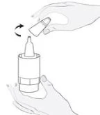 A hand holding a vial while the