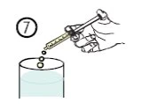 A hand holds a syringe at an angle to let two drops of liquid fall out