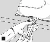 Two gloved hands using a syringe to withdraw liquid from a glass vial through a needle inserted into the rubber stopper