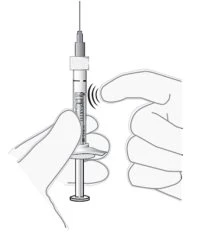 Two hands holding a syringe with the needle pointing upward