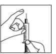 A hand holds a syringe vertically with the