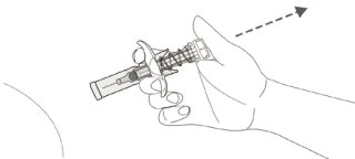 A hand holding a syringe ready for