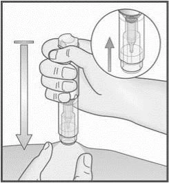 A hand holding a cylindrical medical device for