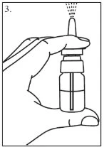 A hand holding vertically a spray bottle emitting a liquid mist from the upper tip