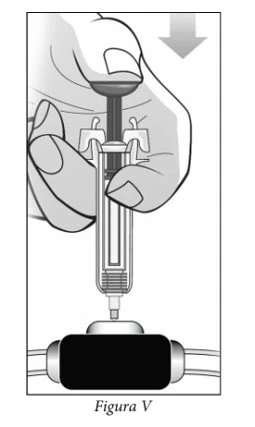 A hand presses the plunger of a syringe to inject its contents into a medical device with a
