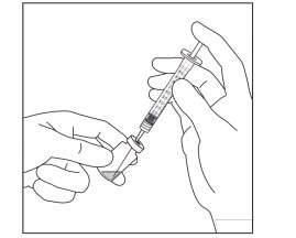 Two hands handling a syringe to draw liquid from a small glass vial through the