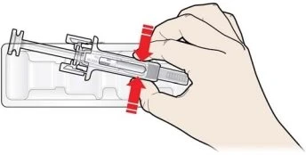 A hand pressing down with fingers on the top of a syringe inserted into a transparent holder, with red arrows indicating downward pressure