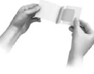 Two hands hold and open a medical device package or vial to reveal the contents against a white background