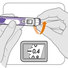 Two hands holding a cylindrical medical device with an orange arrow indicating rotation of the end part above a magnified view of the display
