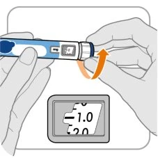 Two hands rotating the top part of a blue and white medical device with an orange arrow and a display showing 1.0 mg