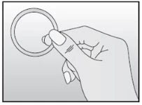A hand holds between the thumb and