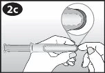 Two hands hold a cylindrical medical device while a
