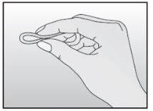 A hand holds a small ring or thin elastic between the thumb and index finger for manipulation or application