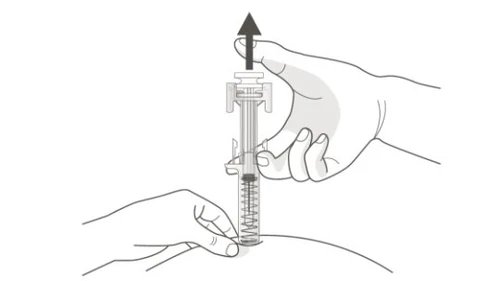 A hand holds the top part of a medical device while the other