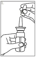 A hand holding a glass vial while the