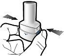 Two hands hold a cylindrical white medical device with black arrows indicating a lateral sliding motion towards the