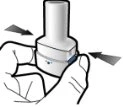 Two hands grip a white cylindrical medical device with black arrows indicating closing or pressing movement toward the center