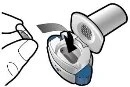A hand opens the cap of a white and blue circular medical device to access the