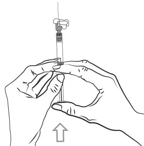 Two hands holding a syringe with the needle pointing upward