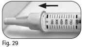 Close-up of a graduated syringe with numbers from 0 to 900 and a black arrow pointing left above the device body