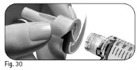 Two hands gently removing a cylindrical protective cover from a medical device for drug administration