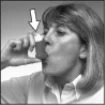 Woman holding a pill near her mouth with a white arrow pointing to the medication ready to be taken