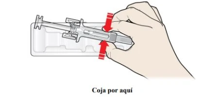 A hand grasps and lifts a syringe-shaped medical device from a transparent plastic container following red arrows