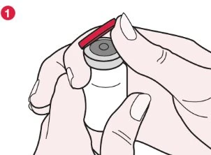 Two hands hold a white vial and remove the red protective cap from the top of the container using the thumb and index finger