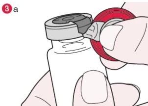 A hand removes the grey protective cap from the top of a white vial to prepare the medication
