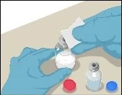 Hands with blue gloves cleaning the cap of a glass vial with a white cotton swab on a light-colored surface