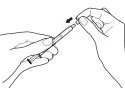 Two hands holding a syringe to remove the cap from the