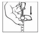 A hand holds a syringe and presses the plunger downward in the direction indicated by a vertical black arrow