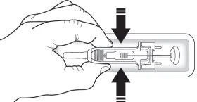 Technical drawing showing a hand holding a transparent medical device and pressing it downward, with two black arrows indicating the direction of pressure