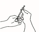 Two hands holding a syringe with needle and medicine vial to prepare the dose