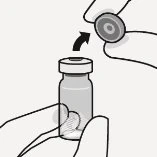 A hand holds a glass vial while another hand prepares to connect it