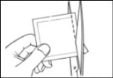 A hand holds a square pouch while a pair of scissors cuts the right side edge to open it
