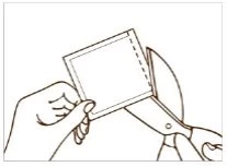 A hand holds a plastic pouch while a pair of scissors cuts along the dotted edge to open it