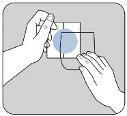 Two hands applying transparent patches onto a white surface with a central blue circle for a medical procedure