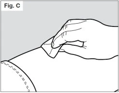 A hand applying an adhesive patch to the upper part of a bare arm with a shirt sleeve visible in the lower left