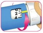 Detail of a blue medical device with a counter numbered from 0 to 4 and a pink arrow indicating rotation of the white part