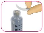 A hand removes the rubber stopper from a glass vial containing a clear liquid with graduated markings from 20 to 60 ml