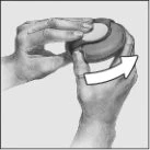 Two hands holding and rotating a circular cap to the right following the direction indicated by a curved white arrow