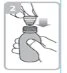A hand holds a medicine vial while the