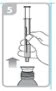 A hand holds a syringe in vertical position above the
