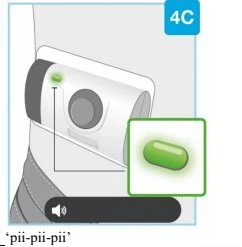 Medical illustration of a white device with a green indicator light and an enlarged detail of a bright green capsule