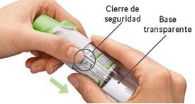 Two hands holding an injection pen with safety lock indications and a transparent base, with a green arrow pointing downward